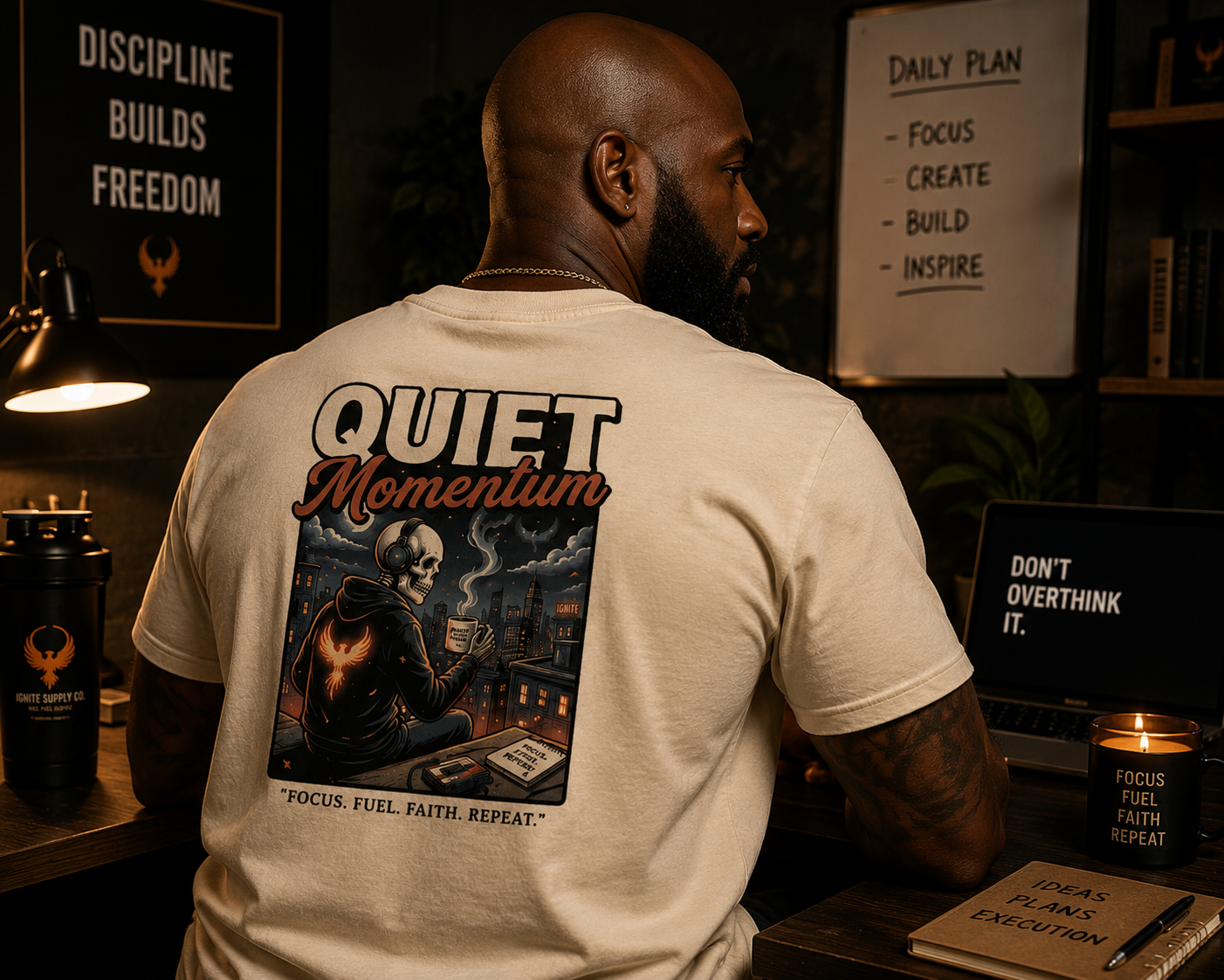 Person wearing a 'Quiet Momentum' t-shirt in a room with motivational posters.