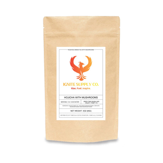 A 300g kraft paper stand-up pouch of Ignite Supply Co. Hojicha with Mushrooms, featuring a white label with an orange phoenix logo.